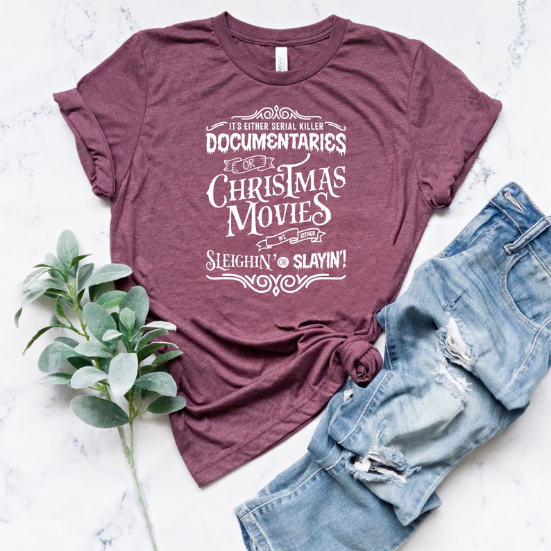 May include: Burgundy t-shirt with white text that reads "It's either serial killer documentaries or Christmas movies, we either sleighin' or slayin'"