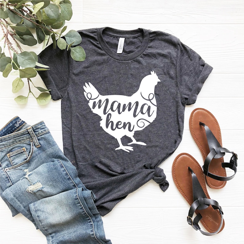 May include: A dark gray t-shirt with a white silhouette of a chicken and the text "mama hen" inside the silhouette.
