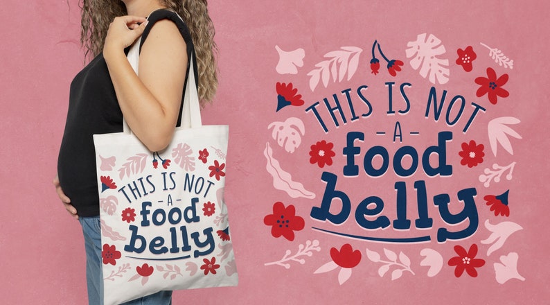 K&ouml;nnte beinhalten: Eine wei&szlig;e Stofftasche mit Blumendesign und dem Text "This is not -a- food belly".