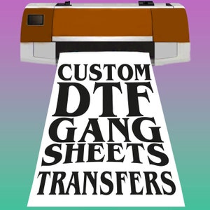 May include: A white sheet of paper with the text "CUSTOM DTF GANG SHEETS TRANSFERS" printed in black letters coming out of a brown and white printer.