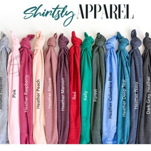 May include: A variety of t-shirt colors, including white, athletic heather, pink, heather raspberry, heather peach, heather mauve, heather maroon, red, kelly green, forest, heather columbia blue, heather deep teal, heather navy, dark grey heather, and black.  Shintsly Apparel.