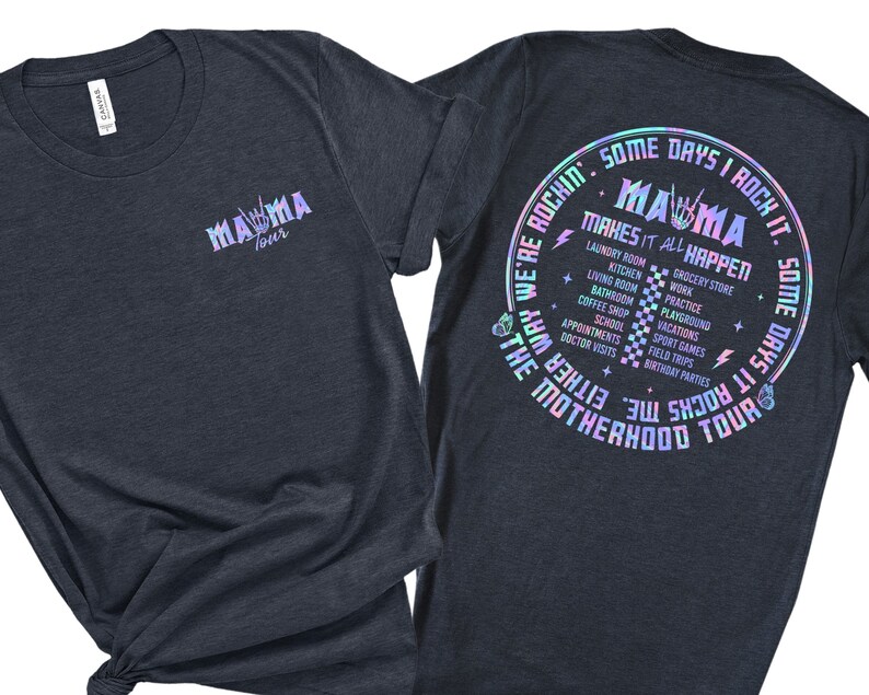 May include: A dark blue t-shirt with a holographic design. The front of the shirt says "Mama Tour" and the back says "Some days I rock it. Some days it rocks me. We're rockin' the motherhood tour. Mama makes it all happen." The design includes a list of activities like laundry, kitchen, grocery store, work, practice, playground, vacations, school, doctor visits, and birthday parties.