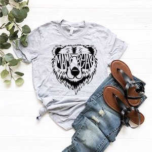 May include: Gray t-shirt with a black bear graphic wearing sunglasses that say "Mama Bear".