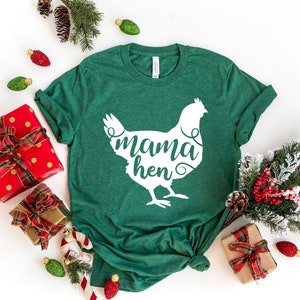 May include: A green t-shirt with a white silhouette of a chicken and the text "mama hen" printed on the front.