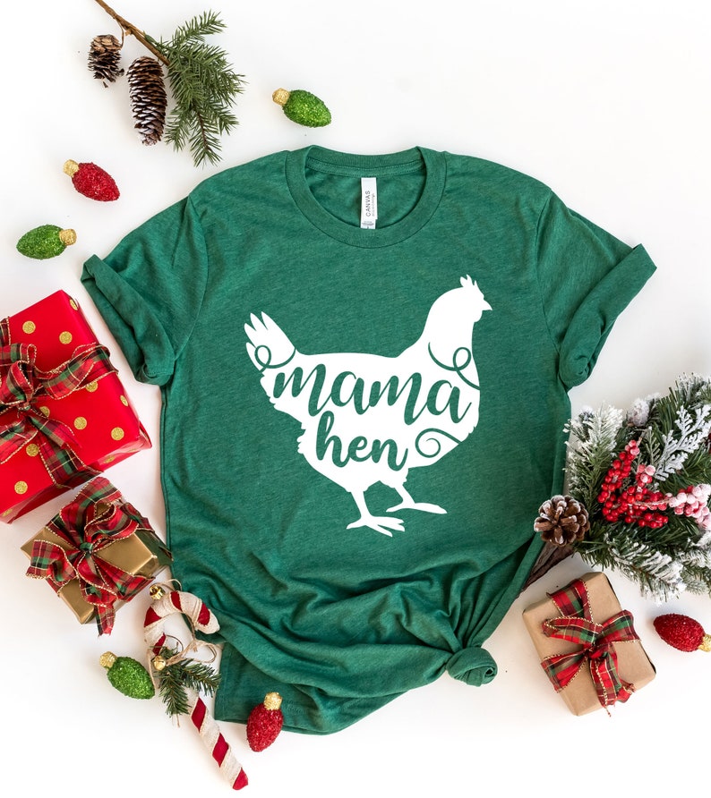 May include: A green t-shirt with a white silhouette of a chicken and the text "mama hen" printed on the front.
