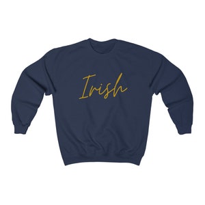 May include: Navy blue sweatshirt with the word "Irish" written in gold script.