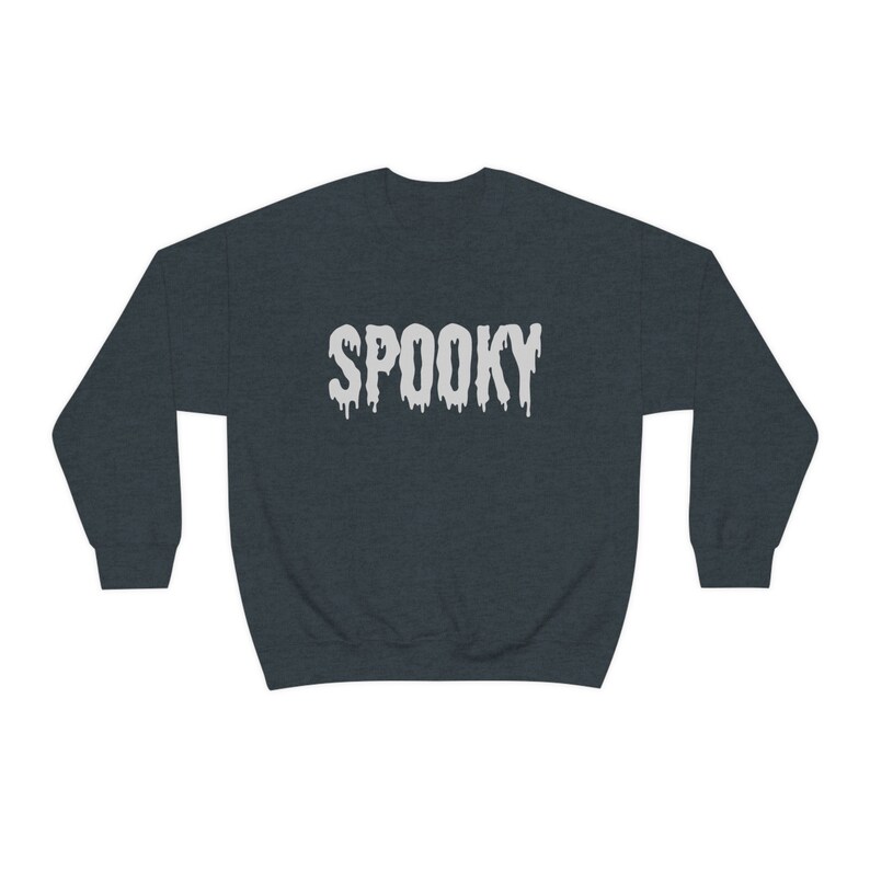 May include: Dark gray sweatshirt with the word "SPOOKY" in white, dripping font. The sweatshirt is a crew neck style, perfect for Halloween or spooky season. The text is centered on the chest.