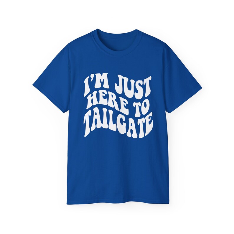 May include: A royal blue t-shirt with white text that reads "I'm Just Here To Tailgate" in a retro font.