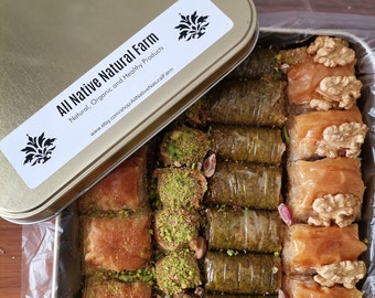 May include: A silver tin with a white label that reads "All Native Natural Farm, Natural, Organic and Healthy Products, www.etsy.com/shop/AllNativeNaturalFarm". The tin is open and filled with a variety of baklava pastries. The pastries are arranged in rows and include pistachio, walnut, and phyllo dough varieties.