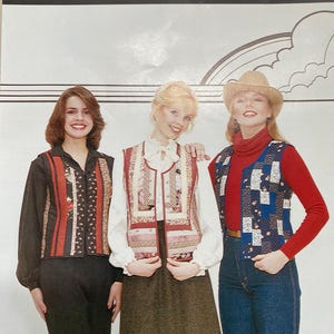 May include: A sewing pattern envelope titled Patches of Joy Laurie Vest 800 featuring three variations of a sleeveless vest. The vests are displayed on three figures wearing different outfits, showcasing patchwork designs with floral and geometric patterns.