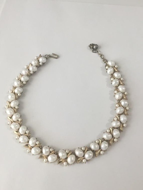 Signed Tafari necklace, featuring gold tone hardware, and faux Pearls