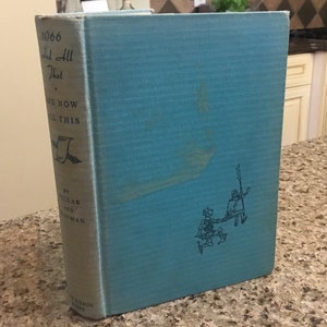 May include: A vintage hardcover book titled "1066 And All That" with a light blue cover. The spine displays the title and author. The cover features a blue illustration of two figures. The book is a historical work.