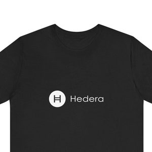 May include: Black t-shirt with a white circle logo featuring the letter "H" and the word "Hedera" in white text.