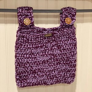 May include: Purple and lavender crocheted tote bag with wooden buttons and a "Hand Made" tag.