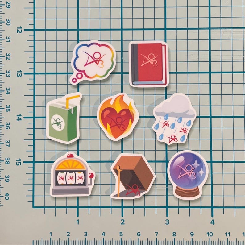 May include: Eight colorful stickers with a logo and various designs. The stickers feature a cloud, a book, a heart, a juice box, a slot machine, a box, a crystal ball, and a rain cloud.