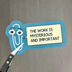 May include: Blue paperclip sticker with googly eyes and a speech bubble that says "The work is mysterious and important".