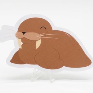 May include: A brown cartoon walrus with white tusks and a white background. The walrus is smiling with its eyes closed.