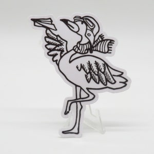 May include: Black and white line drawing of a flamingo wearing a pilot's helmet and scarf. The flamingo is holding a paper airplane in its beak and has its wings spread out.