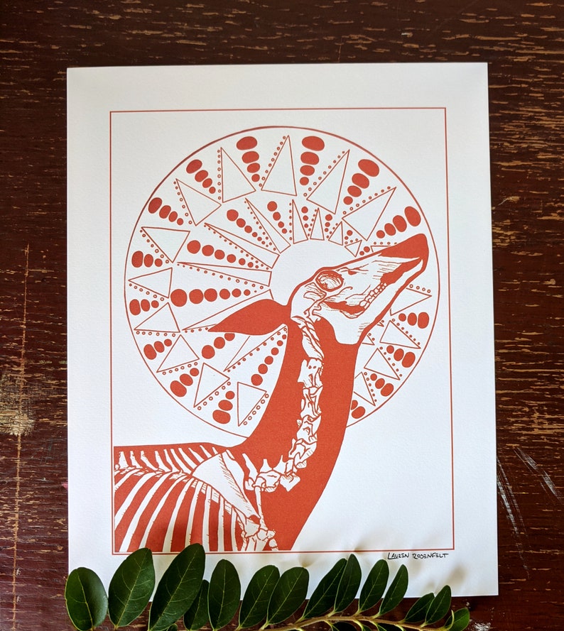 May include: A red and white print of a stylized animal skeleton with a geometric pattern behind it. The print is signed "Leila Rosenfelt".