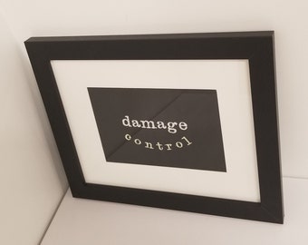 Damage Control glow in the dark framed embroidery wall art, black frame