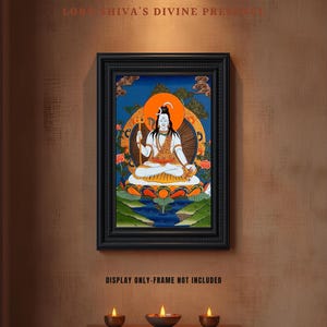 May include: A framed artwork depicting a seated deity with a halo, holding a trident. The painting features vibrant colors, including blue, orange, and gold. The text "LORD SHIVA'S DIVINE PRESENCE" is at the top. The frame is black. The text "DISPLAY ONLY-FRAME NOT INCLUDED" is at the bottom.