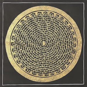May include: A gold-coloured, circular mandala with intricate patterns and text on a black background. The design features concentric circles of script, with a decorative border and a white border around the image. The central symbol is also gold.