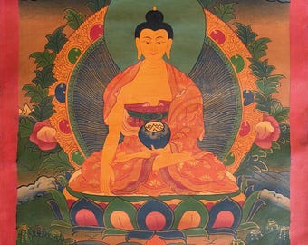 May include: A vibrant, traditional painting of Buddha seated in a meditative pose. The artwork features a warm color palette with orange, yellow, and blue hues. Buddha is surrounded by a halo and lotus flowers, with clouds in the background. The painting is framed in a pink border.
