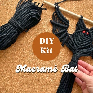 May include: DIY macrame bat kit with black cord and wooden dowel. The kit includes instructions to create a macrame bat wall hanging.
