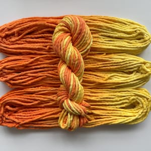 May include: A white ceramic mug with a black handle and the text "But First, Coffee" in a black, bold font. The mug is on a white surface. The mug is likely 11 ounces.