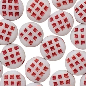May include: A collection of white round beads with a red grid pattern. The beads are approximately 1 cm in diameter.