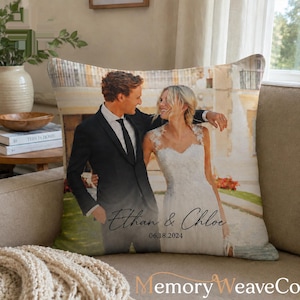 May include: A square throw pillow featuring a printed photograph of a couple in wedding attire. The person on the left wears a black suit, and the person on the right wears a white lace dress. The text Ethan & Chloe and 06.18.2024 is printed.