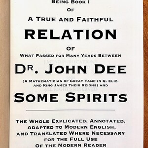 May include: A book cover with the title "Liber Mysteriorum" in large, bold black letters. The text below details the book's contents, including the names "Dr. John Dee" and "Some Spirits". The cover is white with black text.