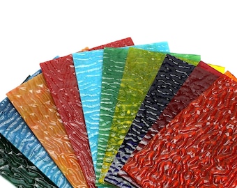 May include: A fan-shaped arrangement of ten textured glass sheets in various colors, including green, blue, red, orange, and yellow.