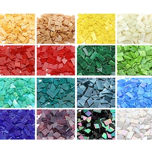 May include: Assortment of 24 colors of glass mosaic tiles. Each color is shown in a separate square. The tiles are irregular in shape and size, with some being square, rectangular, and triangular.