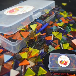 May include: A clear plastic box filled with a large quantity of colorful glass triangle mosaic tiles. The box is labeled "Lanyani Mosaic".