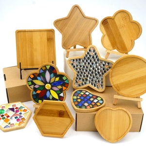 May include: Assortment of wooden coasters in various shapes, including a star, flower, hexagon, heart, and circle. Some coasters are decorated with colorful mosaic tiles.