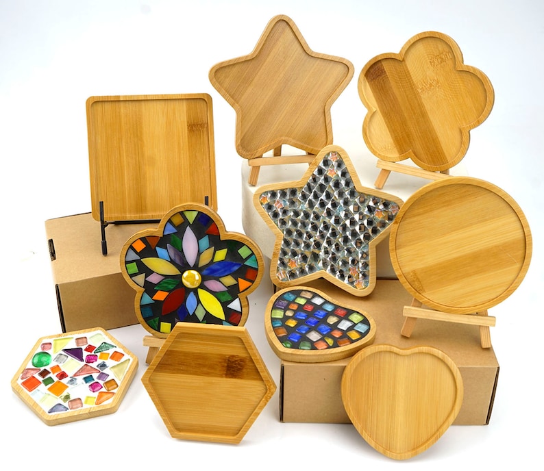 May include: Assortment of wooden coasters in various shapes, including a star, flower, hexagon, heart, and circle. Some coasters are decorated with colorful mosaic tiles.
