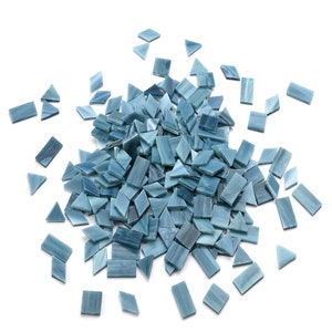 May include: A pile of blue glass mosaic tiles in various shapes, including squares and triangles.