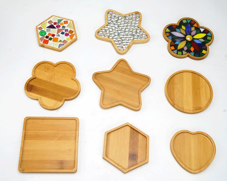 May include: Nine different shaped coasters, some made of wood and some made of mosaic tile. The coasters are in the shapes of a star, a flower, a hexagon, a heart, a circle, and a square.