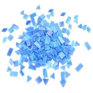 May include: A large pile of light blue glass mosaic tiles in various shapes, including squares and triangles. The tiles are scattered on a white background.