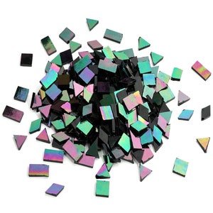 May include: A pile of iridescent black and green glass mosaic tiles. The tiles are in various shapes, including squares, rectangles, and triangles.