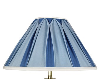 May include: A blue and white striped lampshade with pleats. The lampshade has a white trim around the top and bottom.