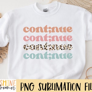 May include: White sweatshirt with the text "continue" repeated four times in different colors. The second "continue" is pink, the third is brown with a leopard print, and the fourth is light blue.