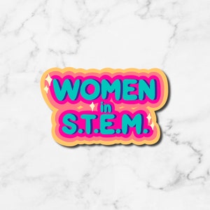 May include: A sticker with the text "Women in STEM" in a colorful, cartoon-style font. The words "Women" are in teal blue and "STEM" is in pink. The sticker has a yellow outline and a white background.