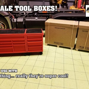 May include: Two red toolboxes with black tops and multiple drawers on wheels. The toolboxes are on a tiled surface. Two cardboard boxes with the text "MAX STACK 2" are in the background.