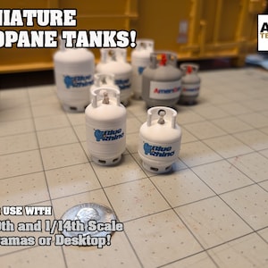May include: A set of miniature propane tanks in white with blue and red labels. The tanks are labeled "Blue Rhino" and "Amerigas". The tanks are for use with 1/10th and 1/14th scale dioramas or desktops.