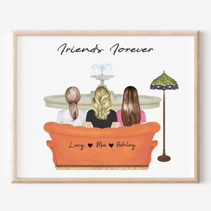 May include: A framed print featuring three figures seated on an orange couch, with a fountain and lamp in the background. The text "Friends Forever" is above the figures, with names "Lucy", "Mia", and "Ashley" on the couch.