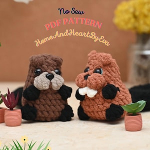 May include: Two handmade crochet beaver plushies in shades of brown, with black accents and white teeth. The plushies are displayed with small potted plants and text that reads "No Sew PDF Pattern Home And Heart By Eva".