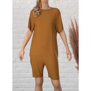May include: A mustard yellow short-sleeved t-shirt and matching shorts set. The top has a round neckline and the shorts have a relaxed fit.
