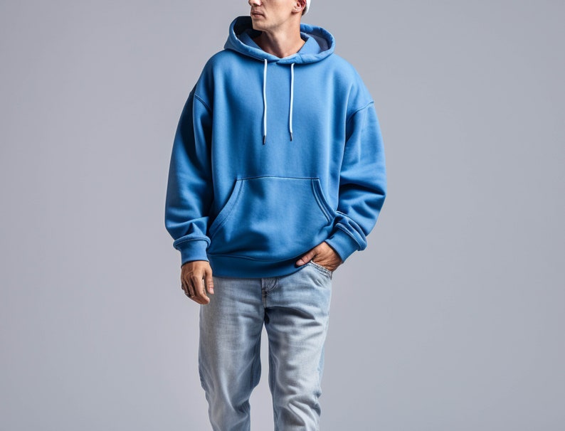 May include: A blue hooded sweatshirt with a pouch pocket and white drawstrings.